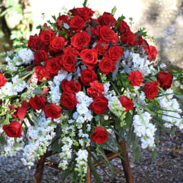 Large arrangement of red roses with white flowers outdoors