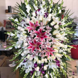 Large standing spray of white and pink lilies with orchids