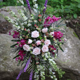 Tall floral spray with pale pink roses and purple and white blooms