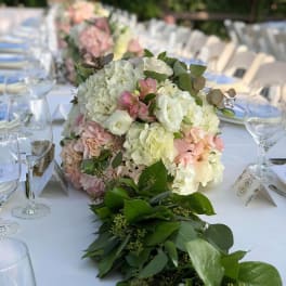 Pastel floral centerpiece on a long banquet table