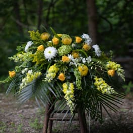 Yellow and white floral arrangement with cascading blooms