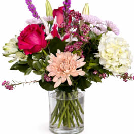 Mixed pink and white bouquet in a clear glass vase