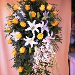 Standing floral spray with yellow roses and white lilies