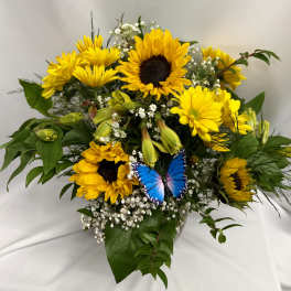 Bouquet of yellow sunflowers and daisies with a blue butterfly decoration