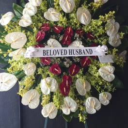Red heart shaped wreath surrounded by Anthuriums and Orchids - F30010