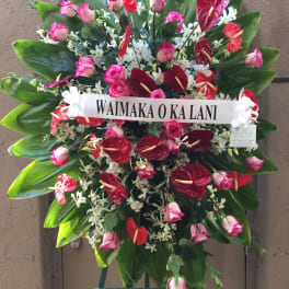 Large standing floral spray with pink roses and red anthuriums