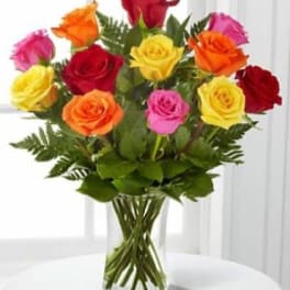 Bouquet of multicolored roses in a clear glass vase