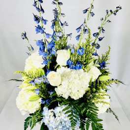 Blue and white floral arrangement in a clear glass vase