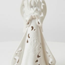 White ceramic angel figurine with cutout details