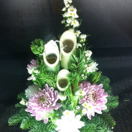Floral arrangement with pink chrysanthemums, white daisies, and bamboo stems