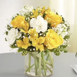 Yellow and white bouquet in a clear glass vase