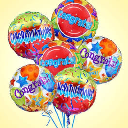 Cluster of colorful congratulatory balloons with star patterns