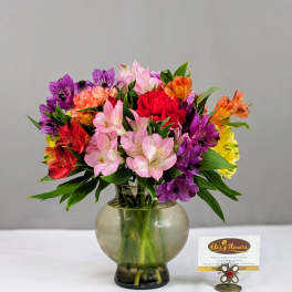 Colorful mixed bouquet in a round glass vase