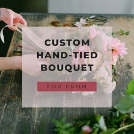 Hand-tied bouquet of pink flowers on a wooden table