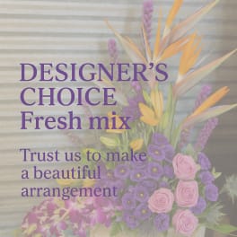 Mixed bouquet with purple and pink flowers in a white container