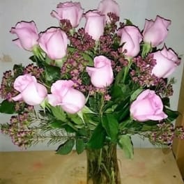 Pink roses arranged in a clear glass vase
