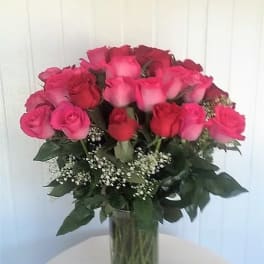 Bouquet of pink and red roses in a clear glass vase