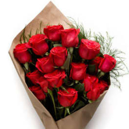 Bouquet of red roses wrapped in brown paper