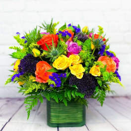 Colorful rose bouquet in a green square vase