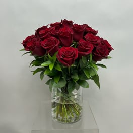 Bouquet of deep red roses in a clear glass vase