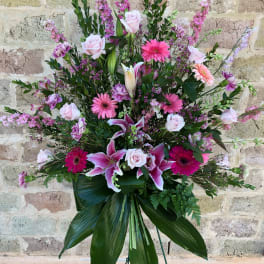 Large pink and white floral standing spray on an easel