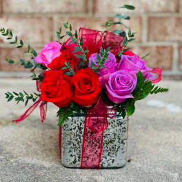 Bouquet of red and purple roses in a square decorative box