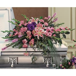 Pink and purple floral spray on a silver casket