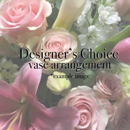 Pink roses and lilies with white flowers in a vase arrangement