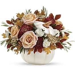 Autumn floral arrangement with roses in a white pumpkin vase