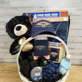 Gift basket with a teddy bear, sports items, and grooming products
