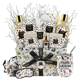 Leopard print spa gift basket with bath products, tumbler, eye mask, and accessories