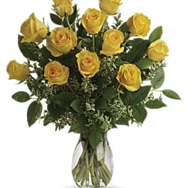 Arrangement of yellow roses in a clear glass vase