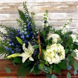 Blue and white floral arrangement in a basket