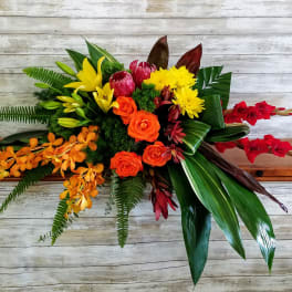 Tropical bouquet with orange roses, yellow lilies, and red orchids