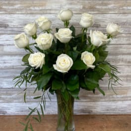 White roses arranged in a clear glass vase