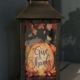 Decorative lantern with a pumpkin and "Give Thanks" text