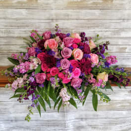 Large bouquet of pink and purple roses with mixed blooms