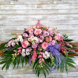 Large pink and lavender floral spray with a purple ribbon