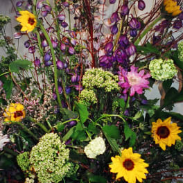Tall mixed bouquet with yellow sunflowers and purple blooms