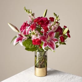 Pink lilies and red roses in a glass vase