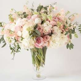 Blush and white bouquet in a clear glass vase