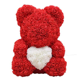 Red rose teddy bear holding a white heart