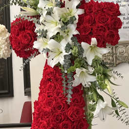 Red rose cross with white lilies and greenery