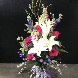 Tall mixed bouquet with white lilies, pink roses, and purple flowers
