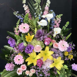 Large mixed floral arrangement with lilies, roses, calla lilies, and gerbera daisies