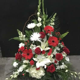 Tall red, white, and green floral spray with roses and lilies
