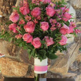 Pink roses and alstroemeria in a clear glass vase