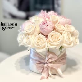 Blush and ivory rose bouquet in a white hatbox with a pink ribbon