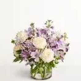 Lavender and white flower arrangement in a glass vase