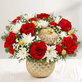 Red roses and white daisies in a gold pumpkin vase